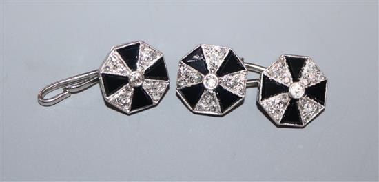 A pair of white metal, black onyx and diamond set octagonal cufflinks, one hallmarked platinum, one link missing.